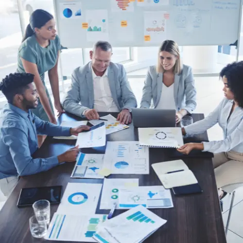 Team of business professionals in a strategy meeting, representing marketing consulting and planning services.